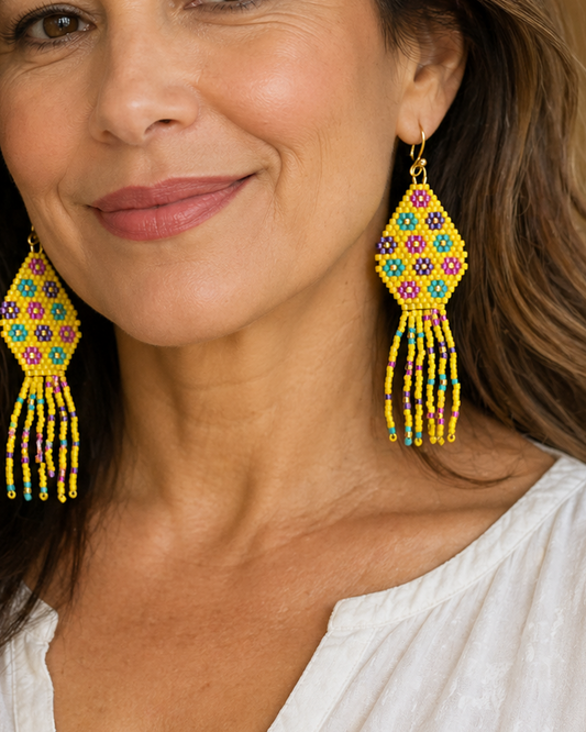 Close-up of a mature woman wearing colorful beaded Miyuki Delica earrings